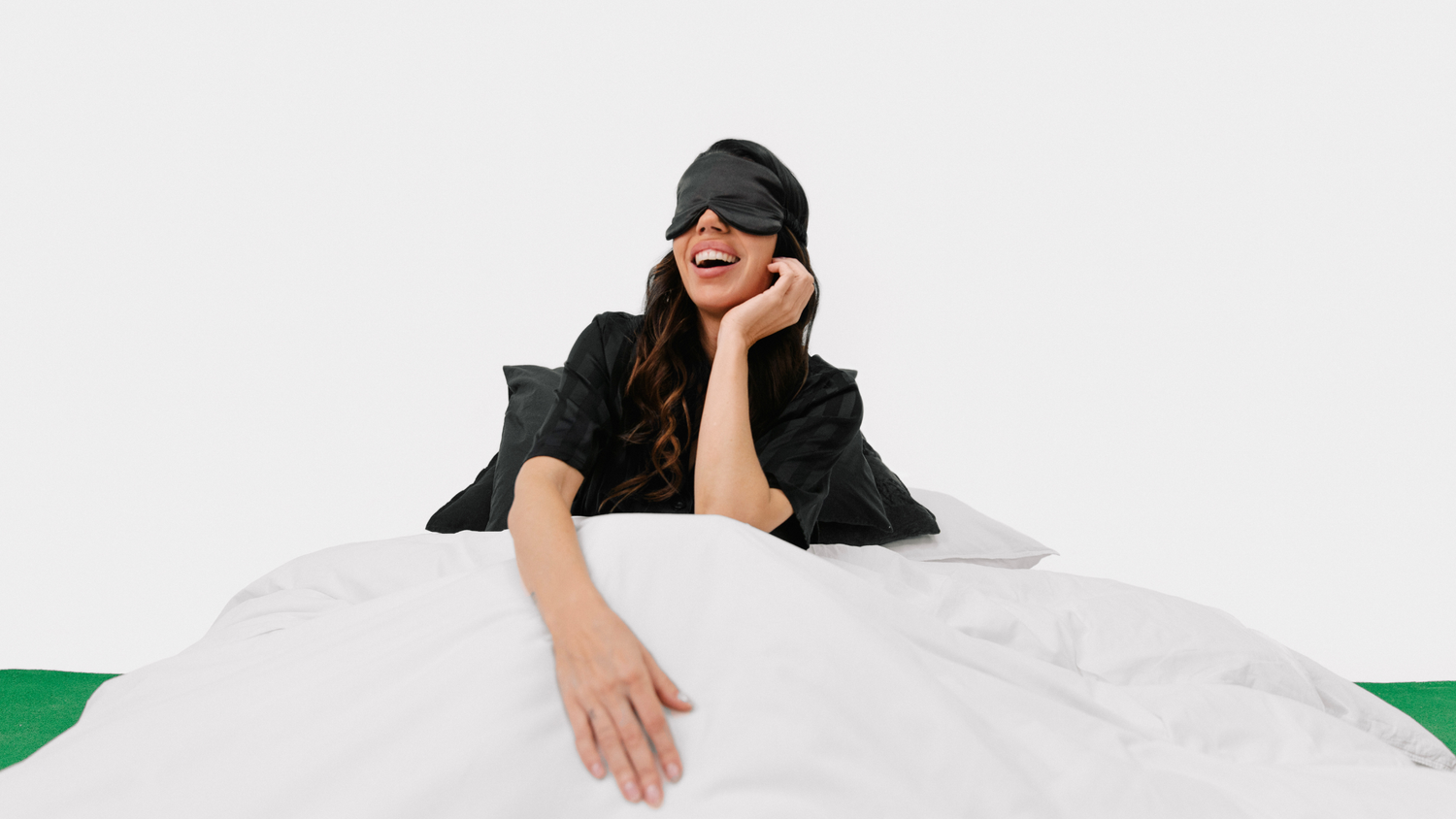 woman waking up in bed full of energy and happy