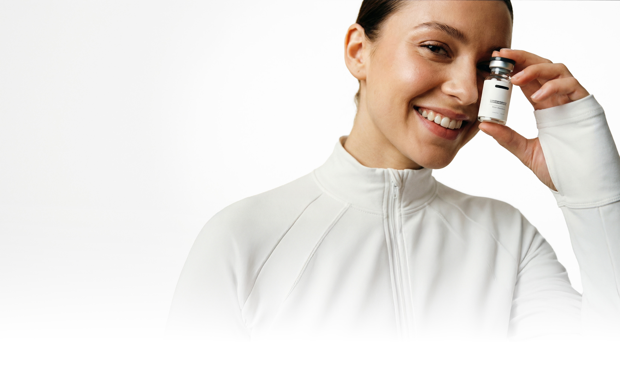 SMILING WOMAN HOLDNG MEDICAL VIAL ON WHITE BACKGROUND