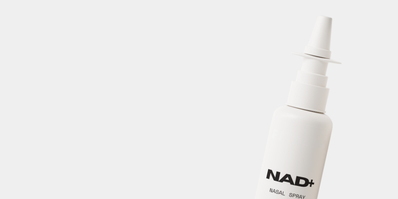 nasal spray bottle labeled nad on white background